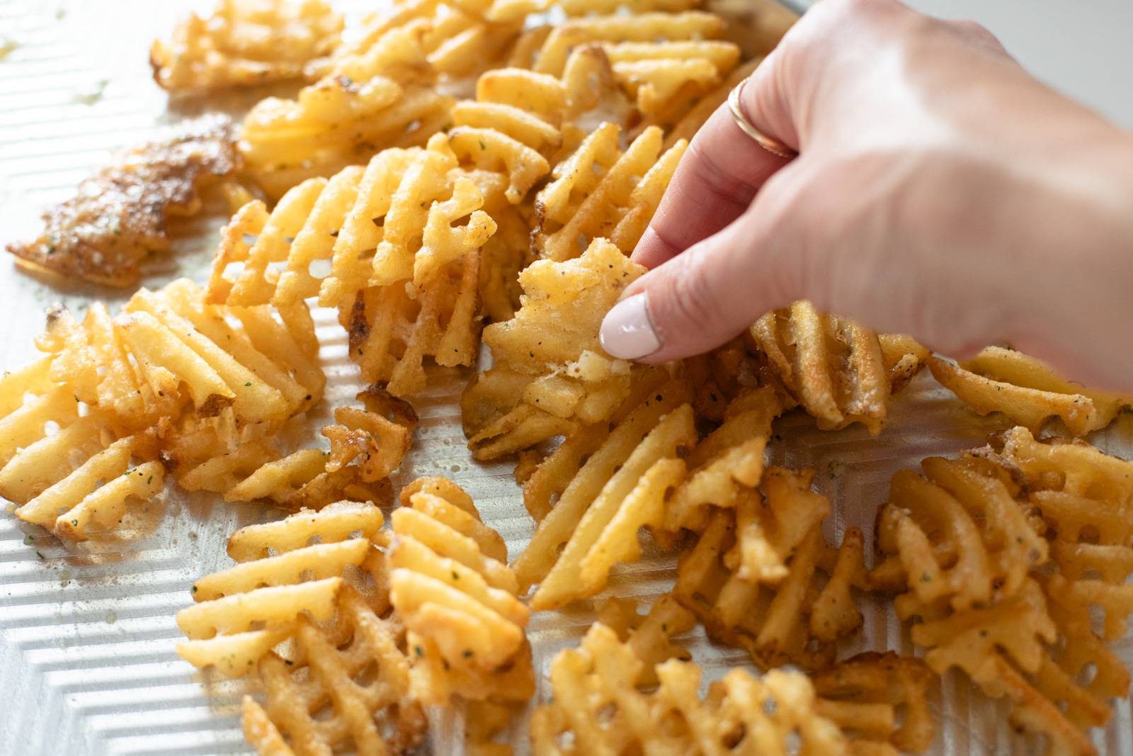 Waffle fries on a sheet pan.