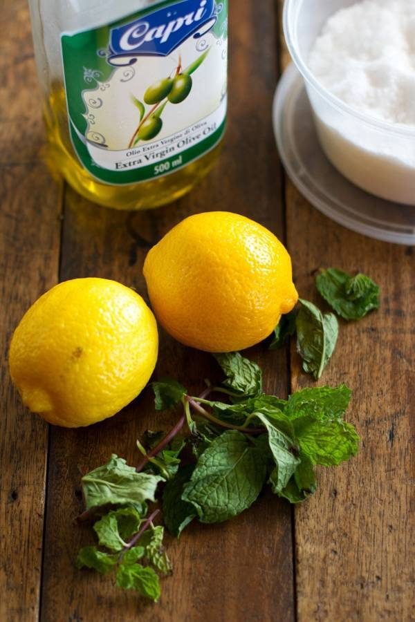Lemons a herbs on a wooden surface.