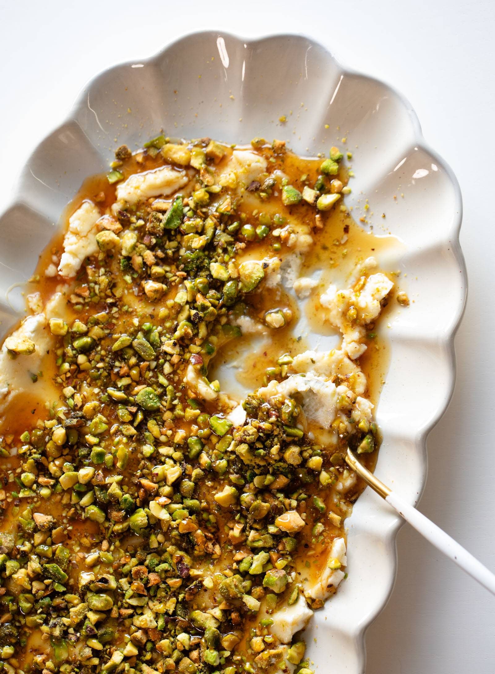 Boursin, pistachios, and hot honey on a plate as an appetizer