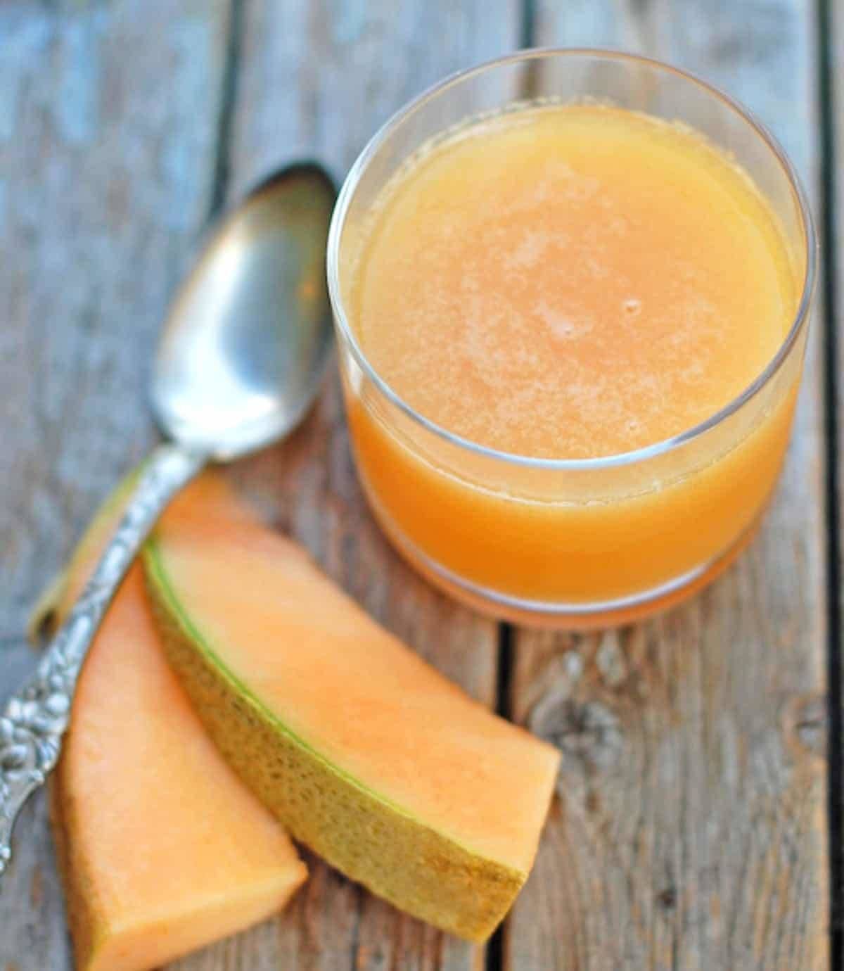 Ginger Melon Chiller in a glass with cantaloupe and a spoon.