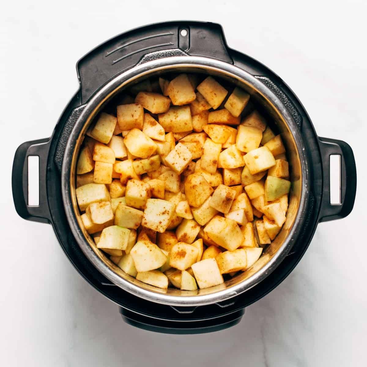 Green apples chopped and in an instant pot with spices
