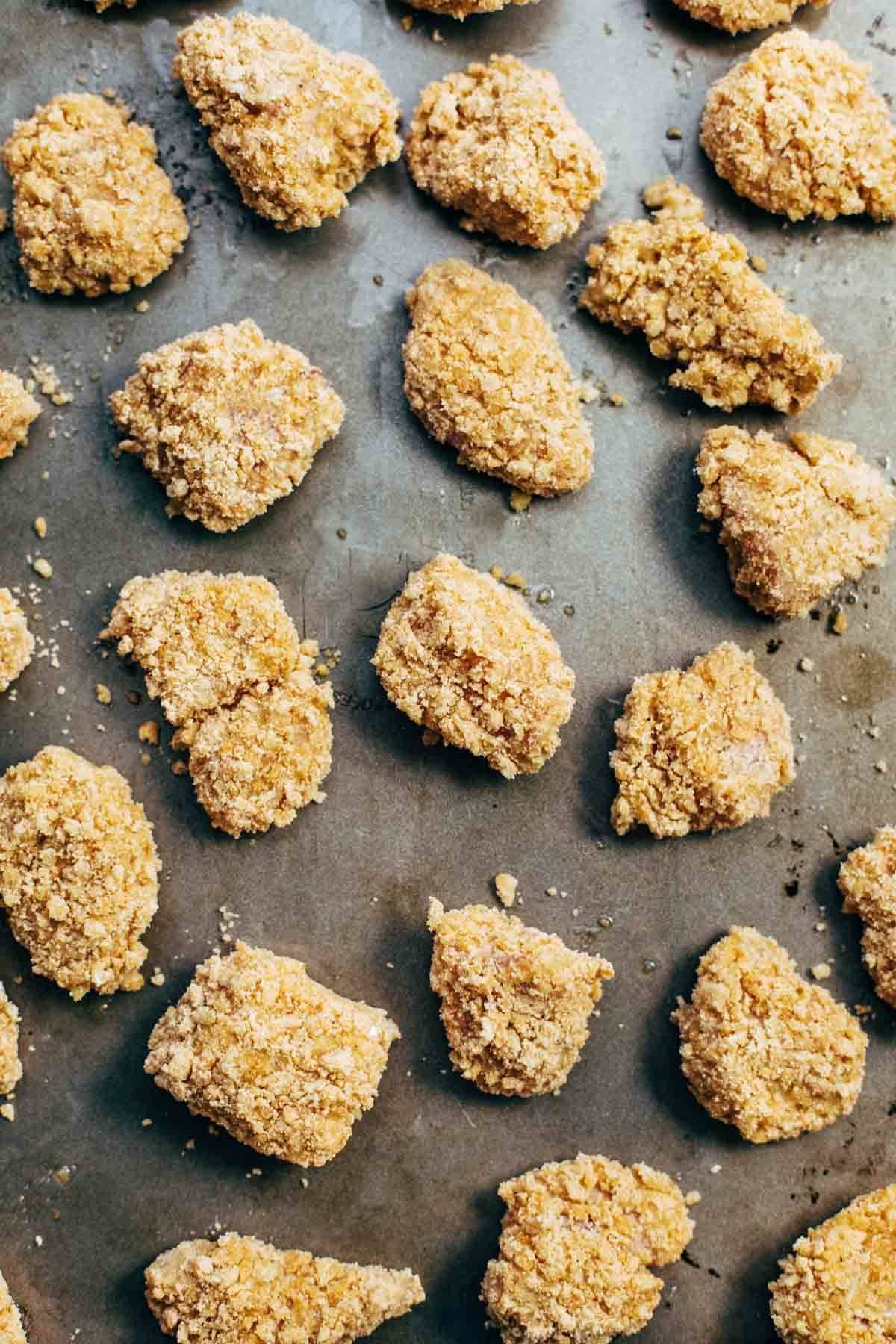 Everyone LOVES these! Baked popcorn chicken that tastes fried! Easy recipe, ready in 30 minutes. SO yummy and fun to share! | pinchofyum.com