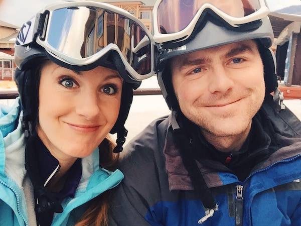 Man and woman wearing ski helmets.