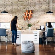 Jenna and Alana working at their desks side by side.