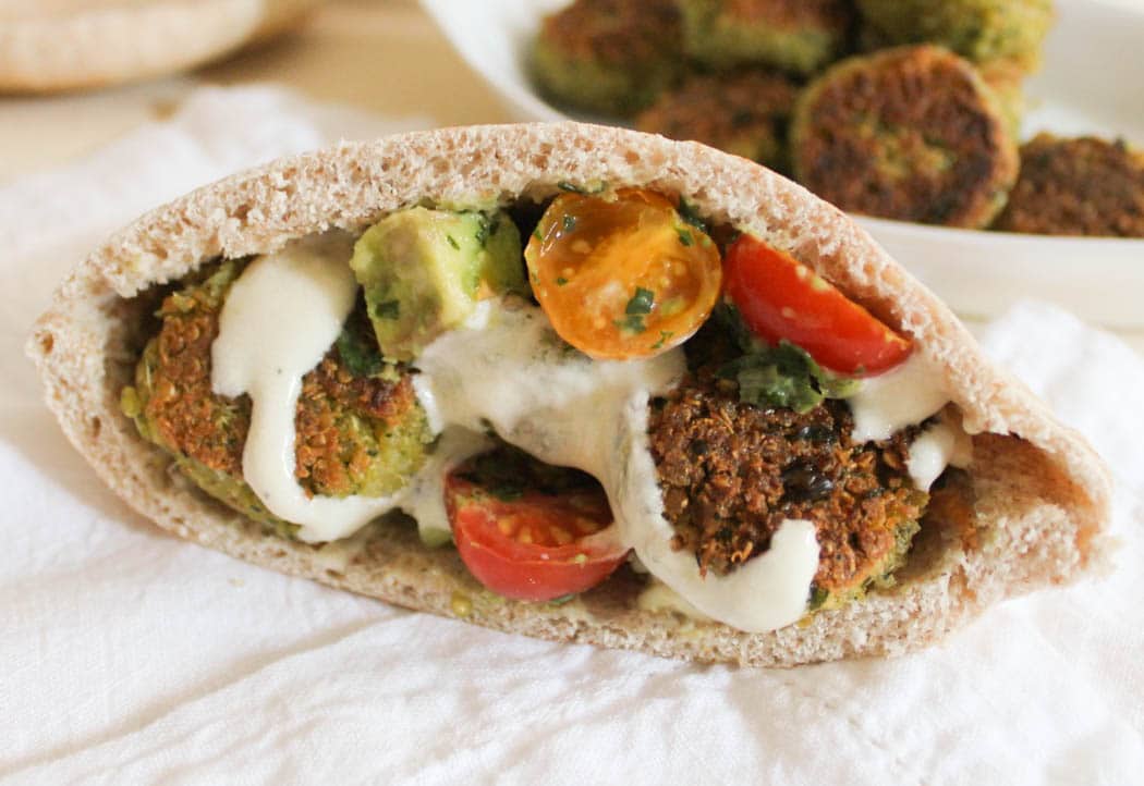 quinoa-falafel-with-avocado-tomato-relish-and-yogurt-tahini-dressing-in-a-pita
