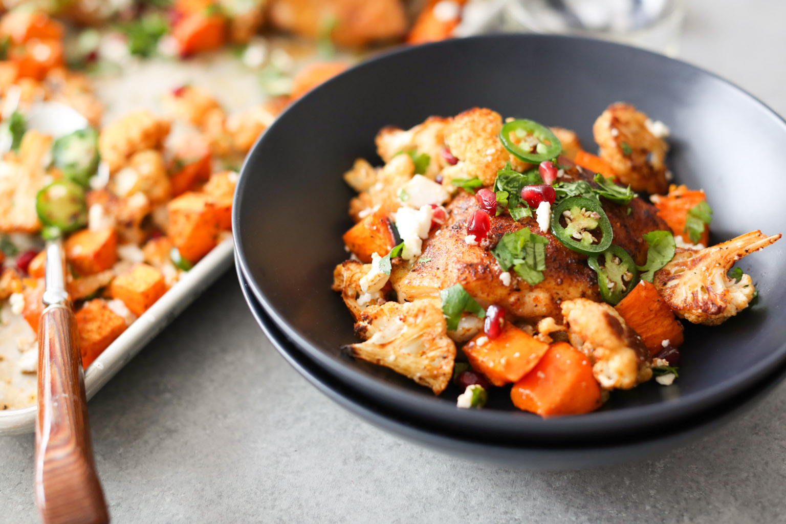 Sheet Pan Chicken Thighs with Cauliflower, Sweet Potatoes, and Pomegranate