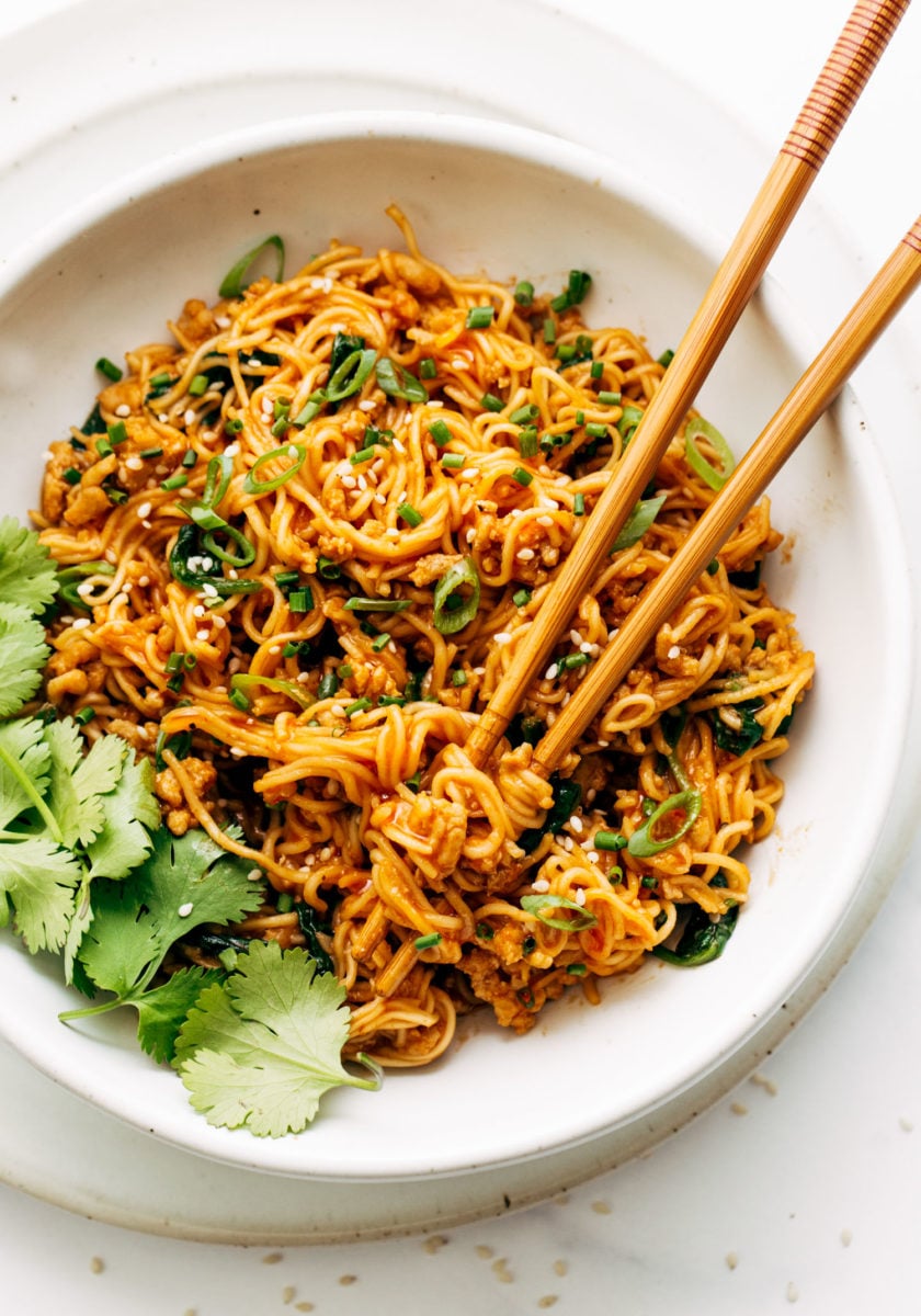 Bowl of gochujang noodles with chopsticks.