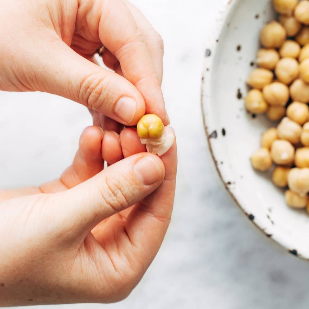 Peeling skin off chickpeas.
