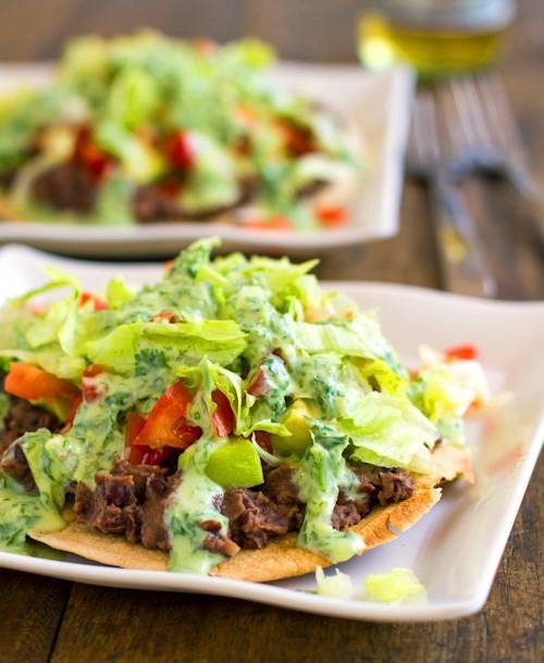 Black bean tostadas drizzled with a homemade healthy cilantro sauce.