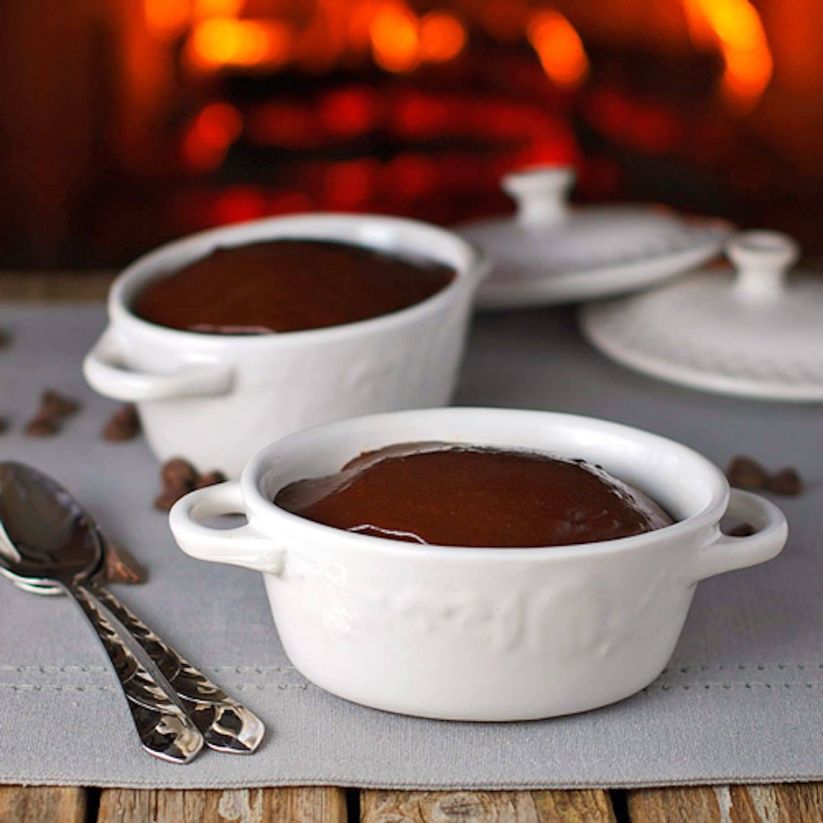 Chocolate cherry fudge cake topped with homemade fudge frosting in two white dishes.